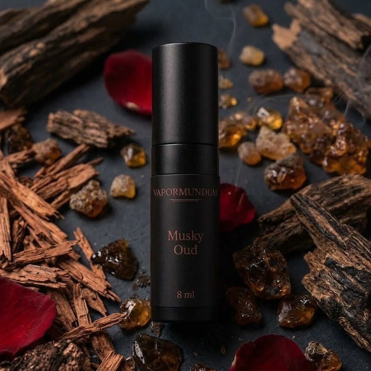 vapormundum Musky Oud 8ml layering accord atomizer styled on dark slate with raw agarwood bark, amber resin, and rose petals