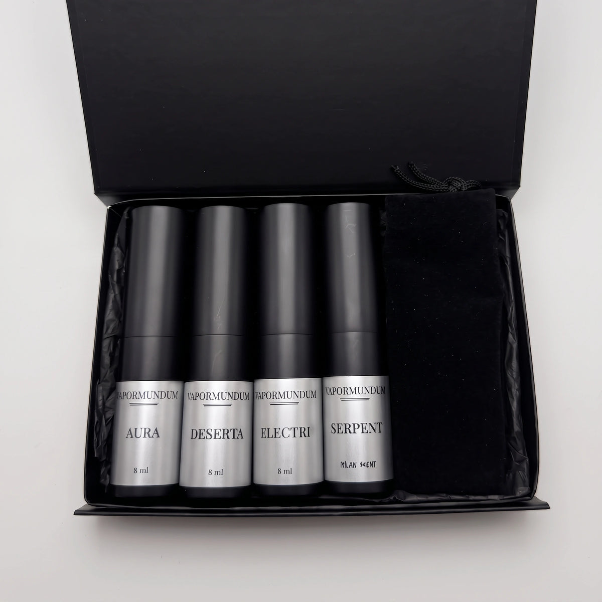 VAPORMUNDUM Discovery Travel Collection open black box with four 8ml matte black perfume atomizers and velvet pouch